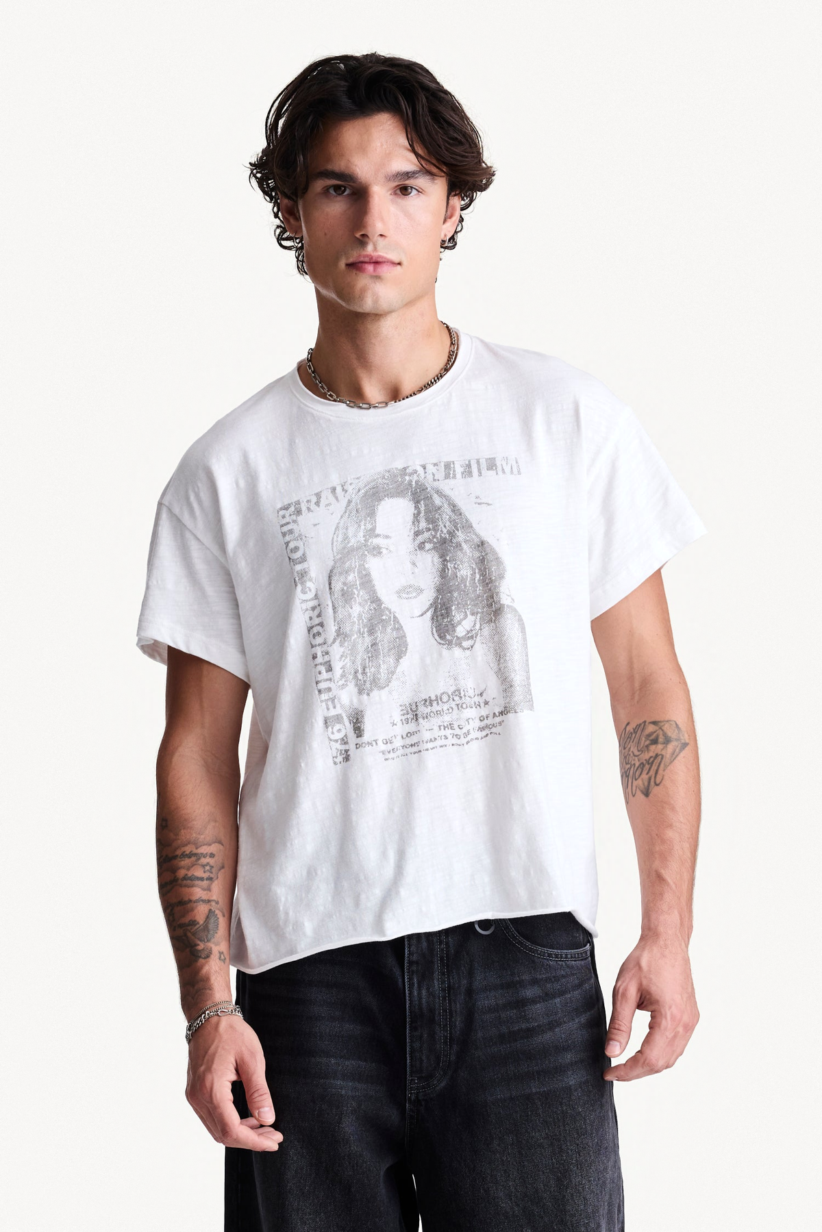 White Dreamer Slub Tee worn on a model, with chest graphic and raw hem