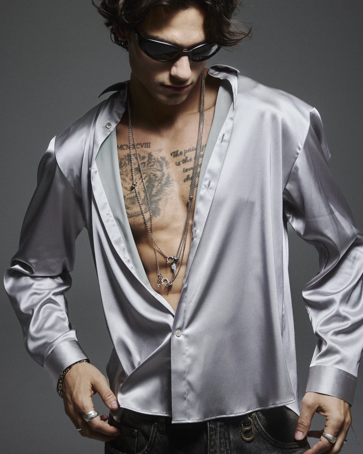 Model wearing the silver Signature Satin Shirt, showing its sheen and fluid drape.