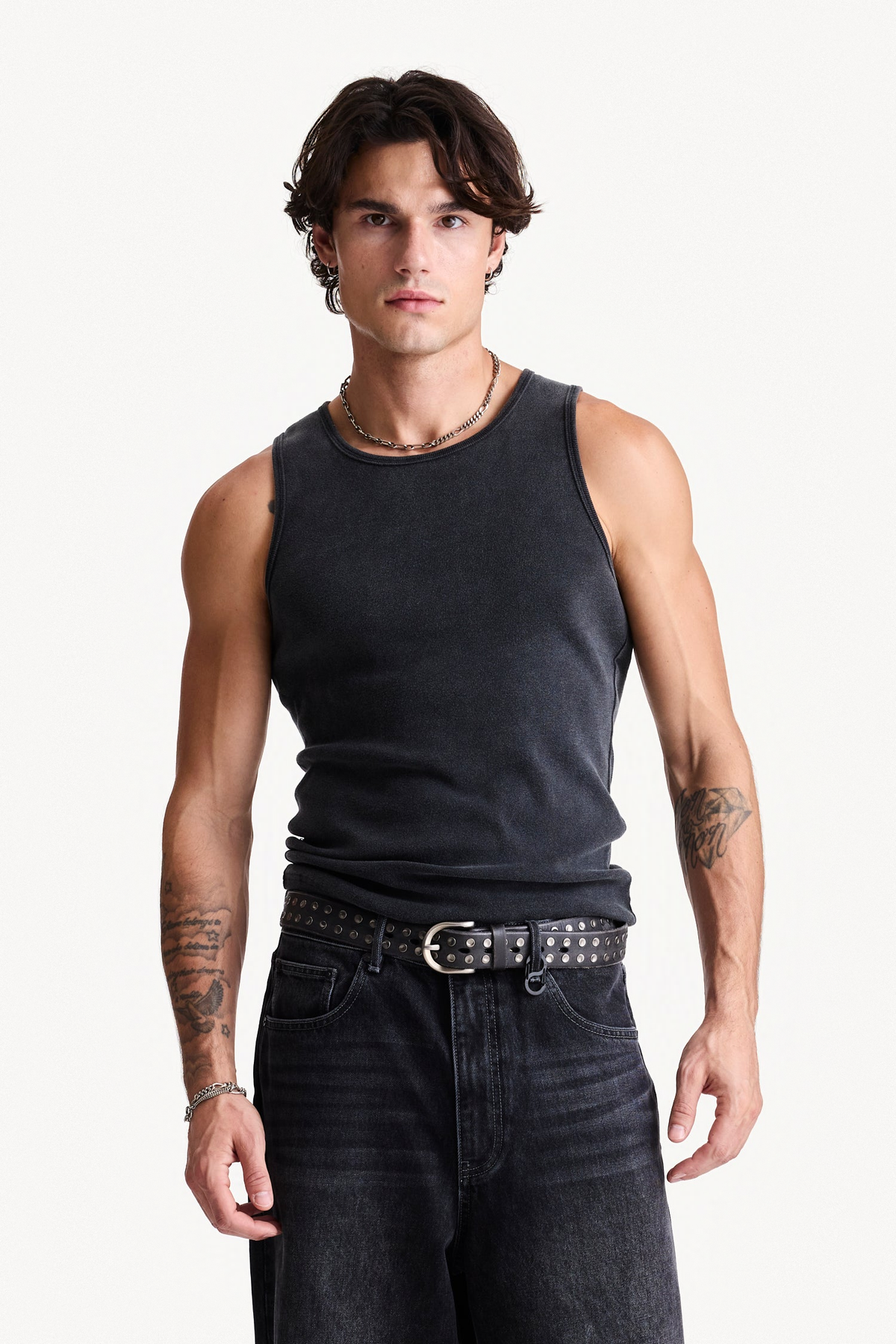 Grey Core Singlet worn on a model, showing the ribbed fabric and bound openings